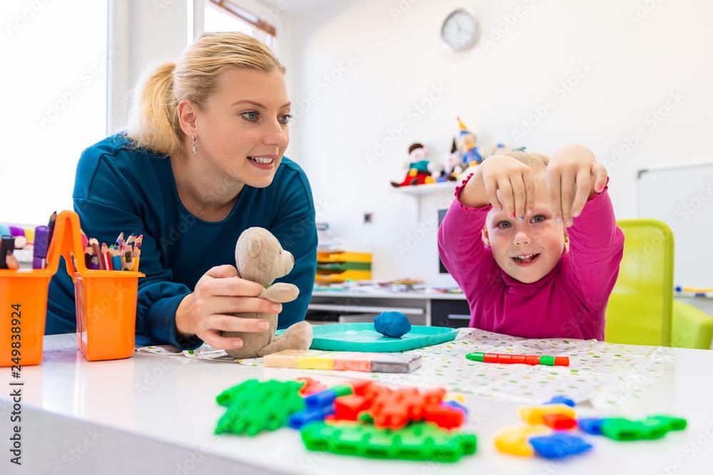 Teacher working with a child on occupational therapy