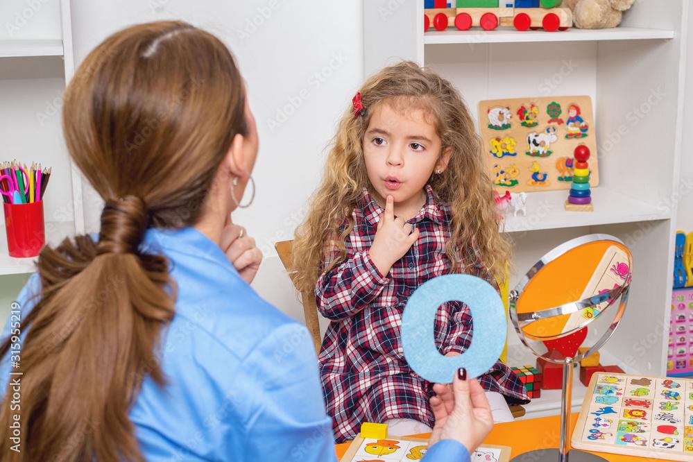 Techer working with child on speech therapy